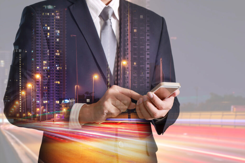 Double exposure of man in a suit holding a phone