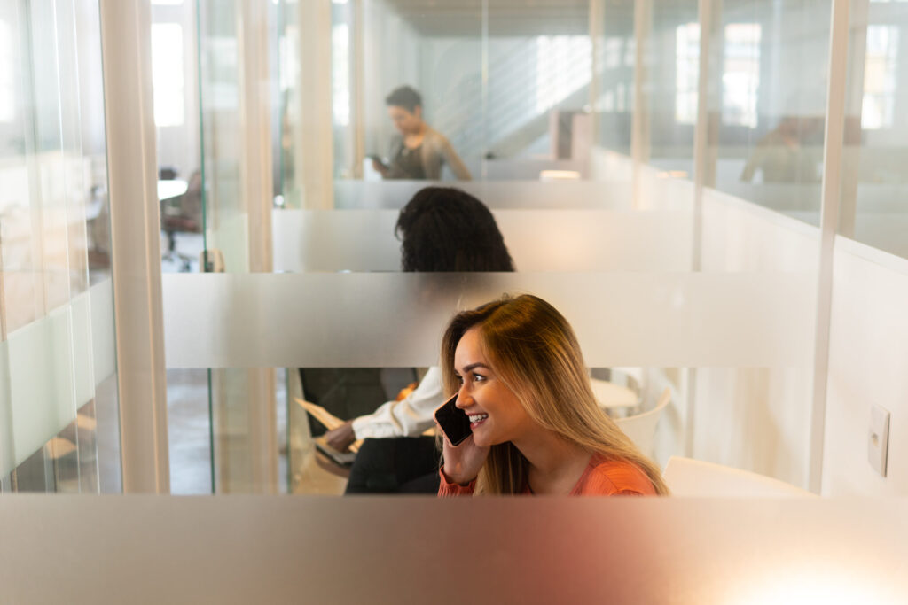 Woman on the phone inside meetingbooth